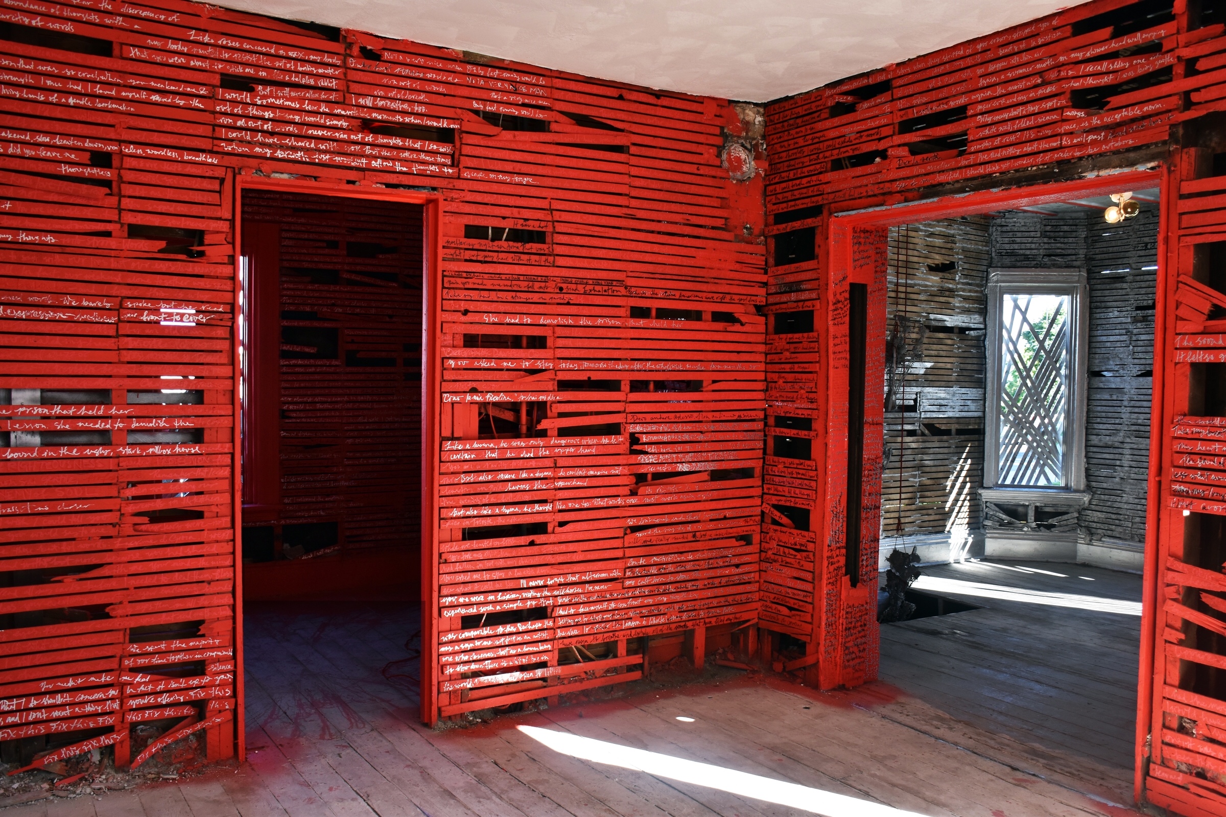 At the Former Residence of 339 Franklin SW, Grand Rapids, MI. Included aluminum and bronze lost-wax casted elements (suspended floral bouquets). This large-scale installation was located in an abandoned home in the decommissioned Rumsey Street Neighborhood. For ArtPrize 2016, Volwiler-Stanley took part in an exhibition hosted by SiTE:LAB, an installation-based arts organization in Grand Rapids. "The Gingerbread Girl" was an architectural intervention in which Volwiler-Stanley removed the plaster from the walls of four rooms in the home, exposing the lath beneath. The lath became like "lines in a journal," laying bare private writings by the artist. The personal writings are juxtaposed with passages from the harrowing novella "The Gingerbread Girl" by Stephen King, a story of a woman who evades the grip of a serial killer. The repetition of the lines of the lath - in both physical form as well as light and shadows - creates an air of confinement.