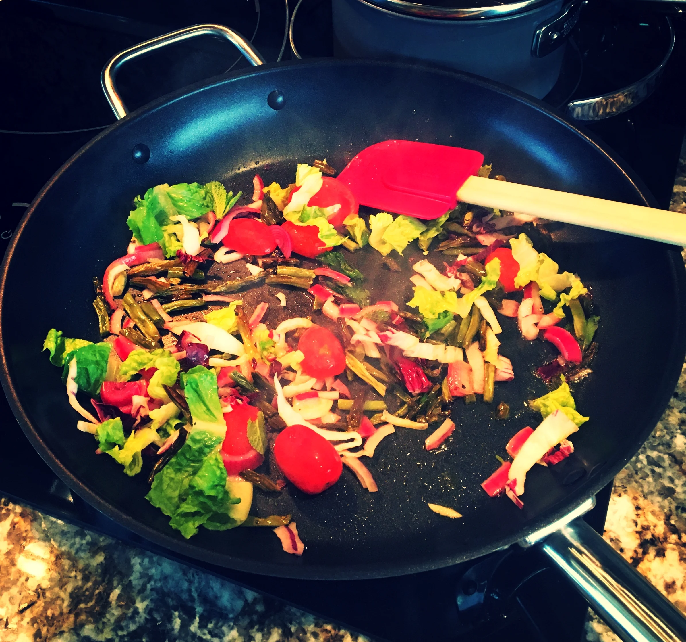 A whole bunch of leftovers being sautéed in a pan