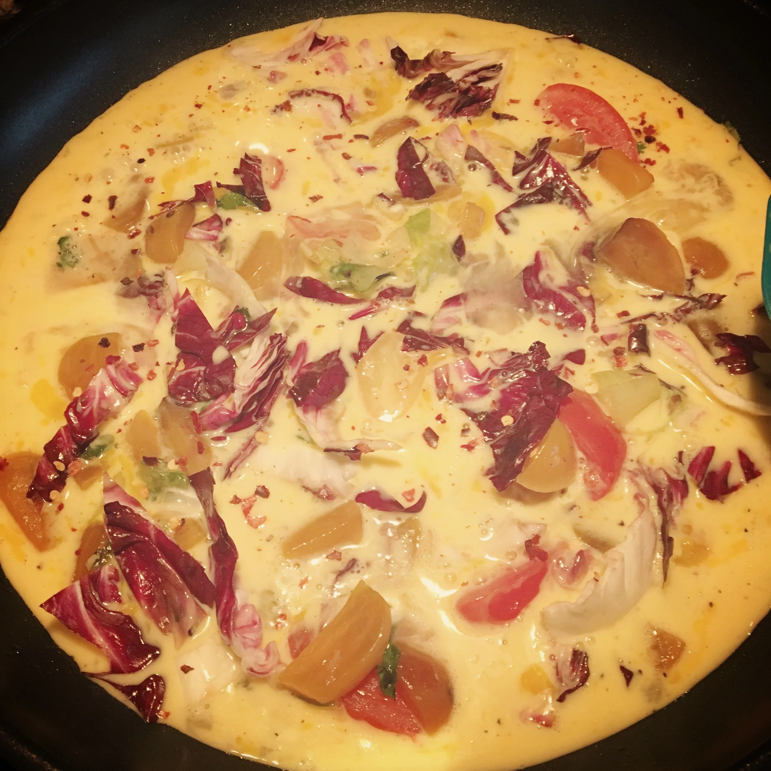 Same vegetables with the beaten eggs in the pan.