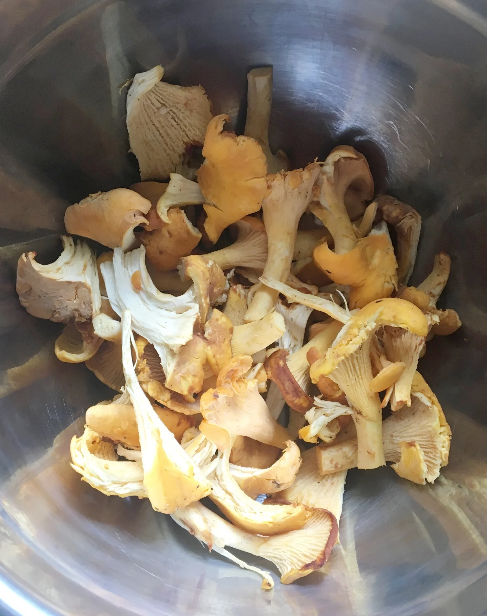 Chanterelles that have the dirt brushed off and I have shredded/sliced.