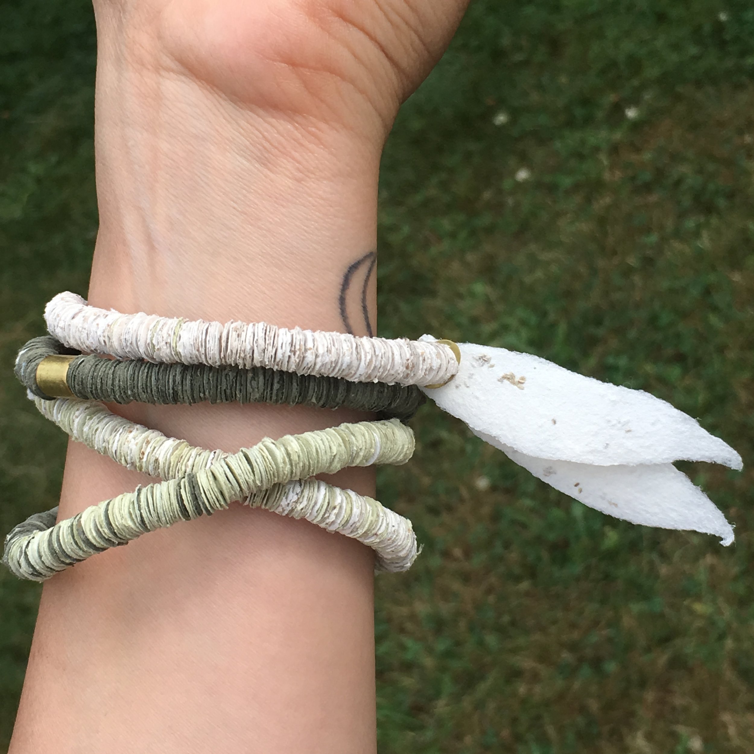  This piece can be worn as a necklace or wrapped around the wrist and worn as a bracelet. It works like the other disc bracelets and necklaces - the discs can be torn off or unbuckle the clasp and slide them off and plant them - but uses smaller disc