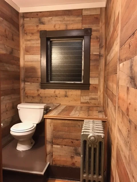 After: We replaced the tile with wood paneling and painted the floor.