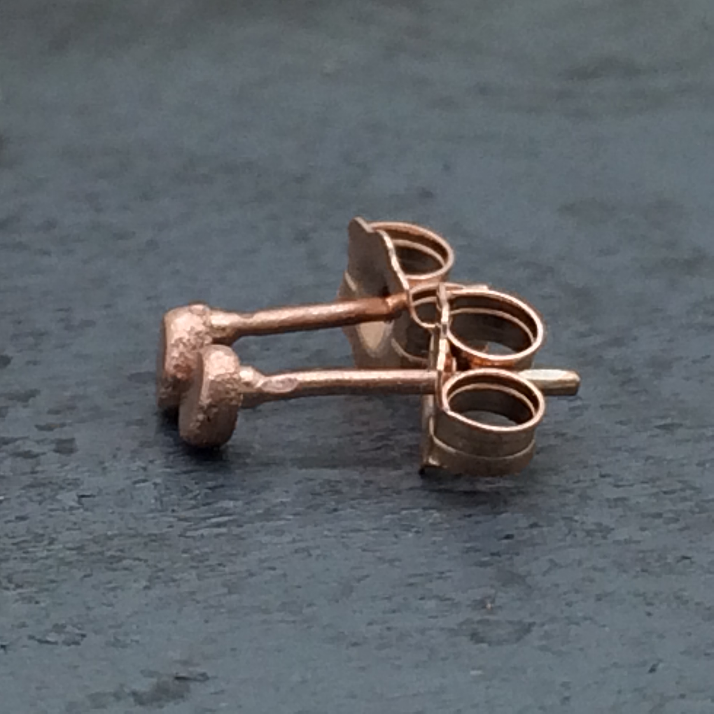 14k rose gold hammered pebble studs side view.jpg