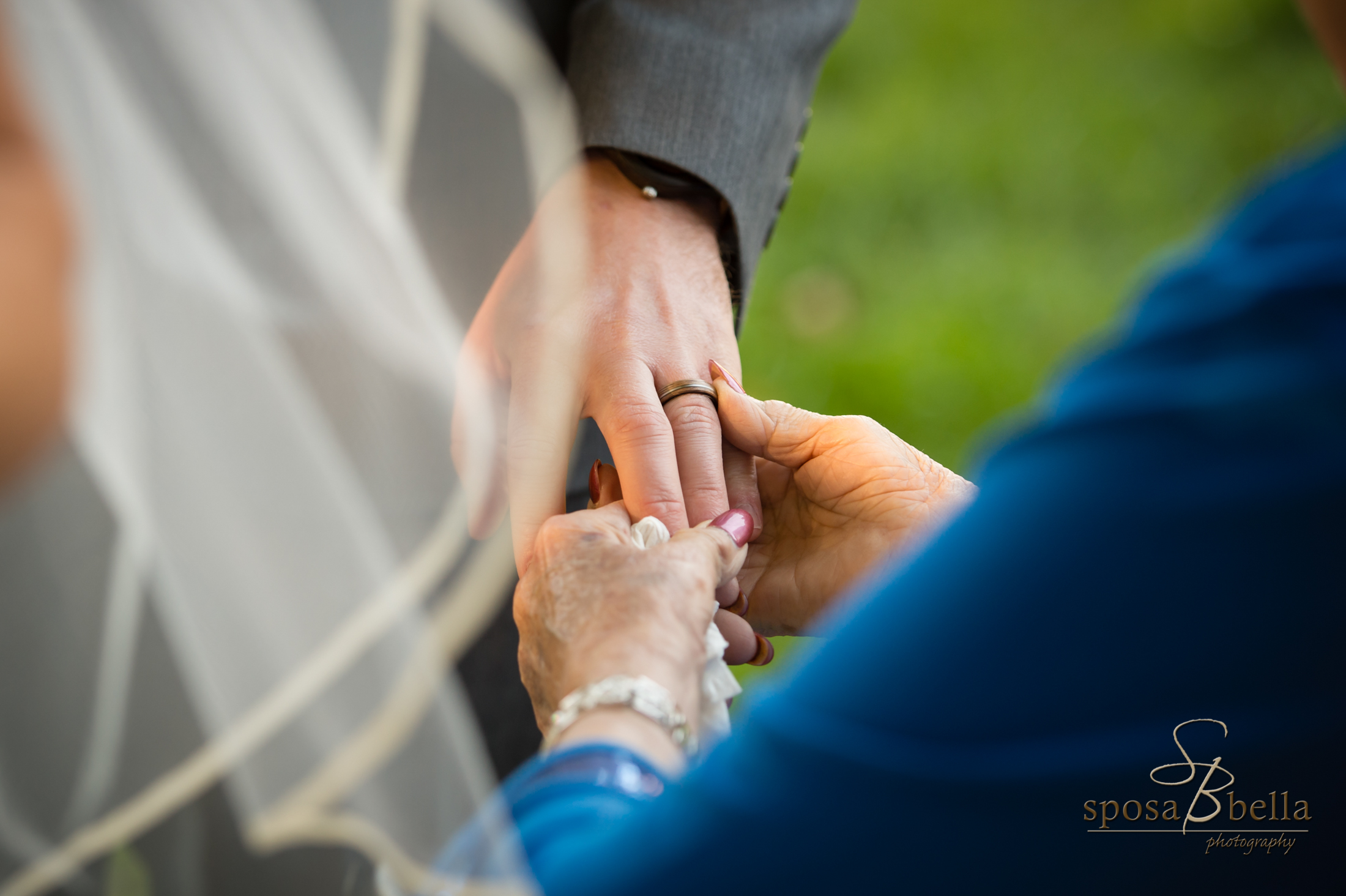 A beautiful moment captured as a Grandmother admires the Groom's new accessory.