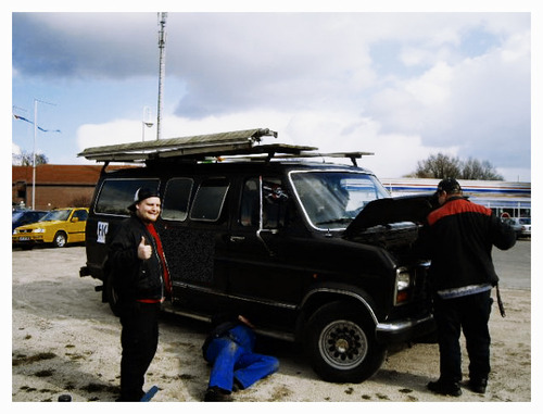 (Bowie and some mechanics trying to patch up the transmission.)