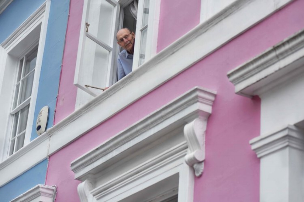 Man looking out of his appartment, Notting Hill, London, U.K. Image©thingstodot.com