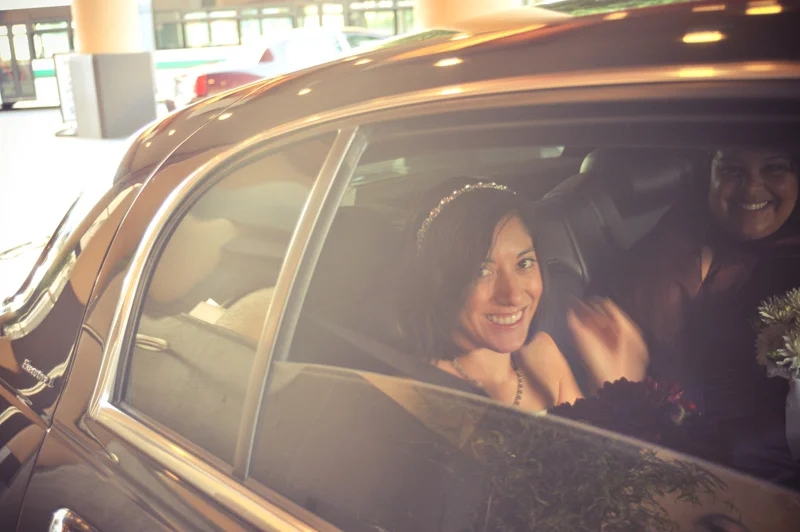 Bride looking out window of limo in Oakland, CA. Photo by e&b photography