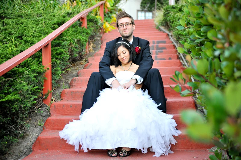 Bride and Groom sitting on stairs near Lake Merritt in Oakland, CA
