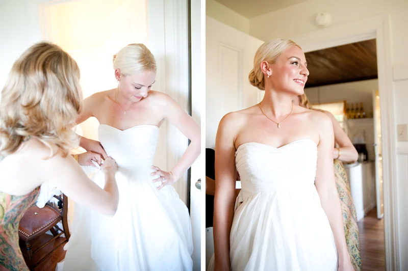 Bride getting into wedding dress inside cabin at Mar Vista Cottages