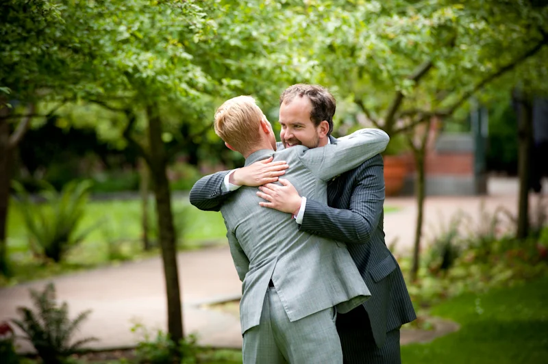Groom hugging guest