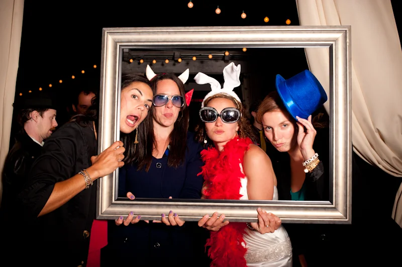 Bride with friends at photobooth