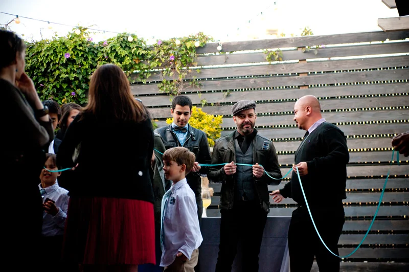 Guests holding ring warming string