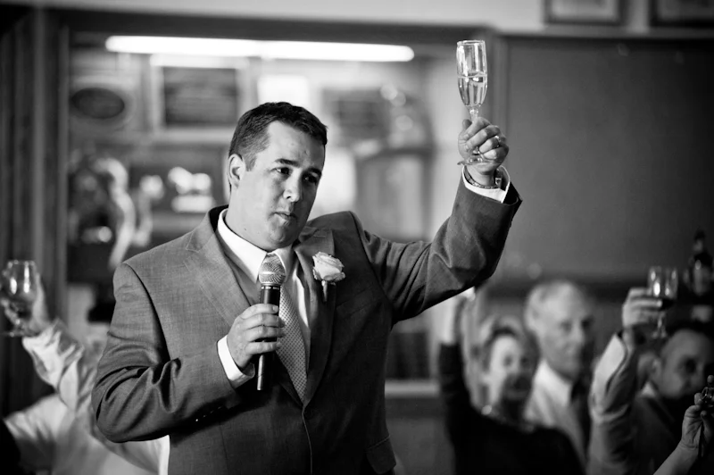Best man raising glass for toast