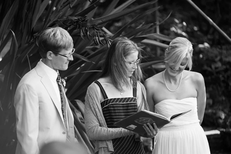 Wedding guest reading passage from book during ceremony