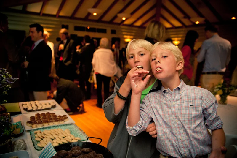 Young boys enjoying dessert bar at wedding