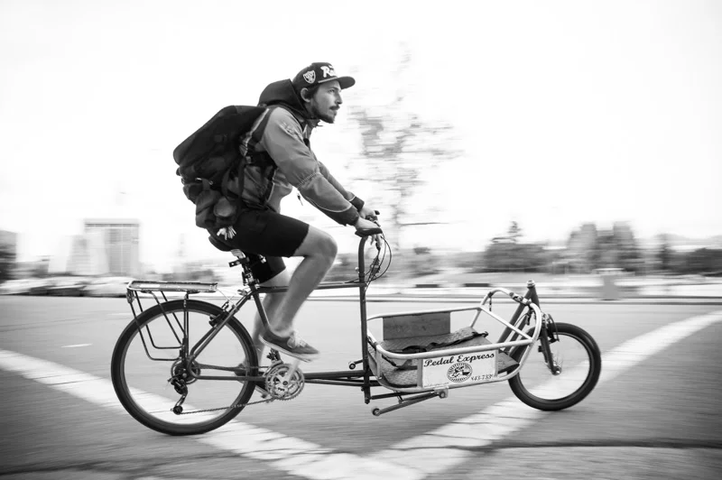 Action shot of bike messenger in Oakland, CA