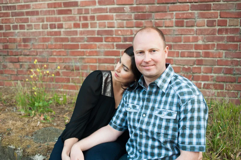 Engaged couple in San Francisco presdio in front of brick wall