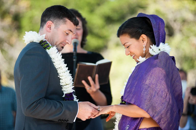 Exchanging of rings during wedding at Lake Merritt band stand in Oakland