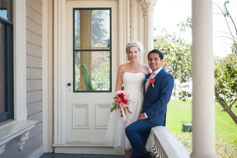Bride and Groom on the porch of the Camron-Stanford house in Oakland