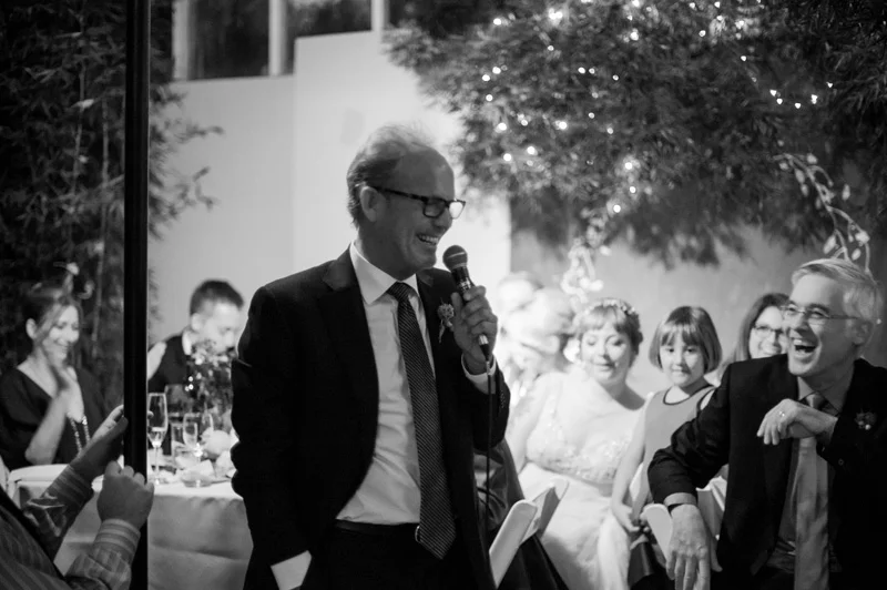 Father of bride giving toast in greenhouse