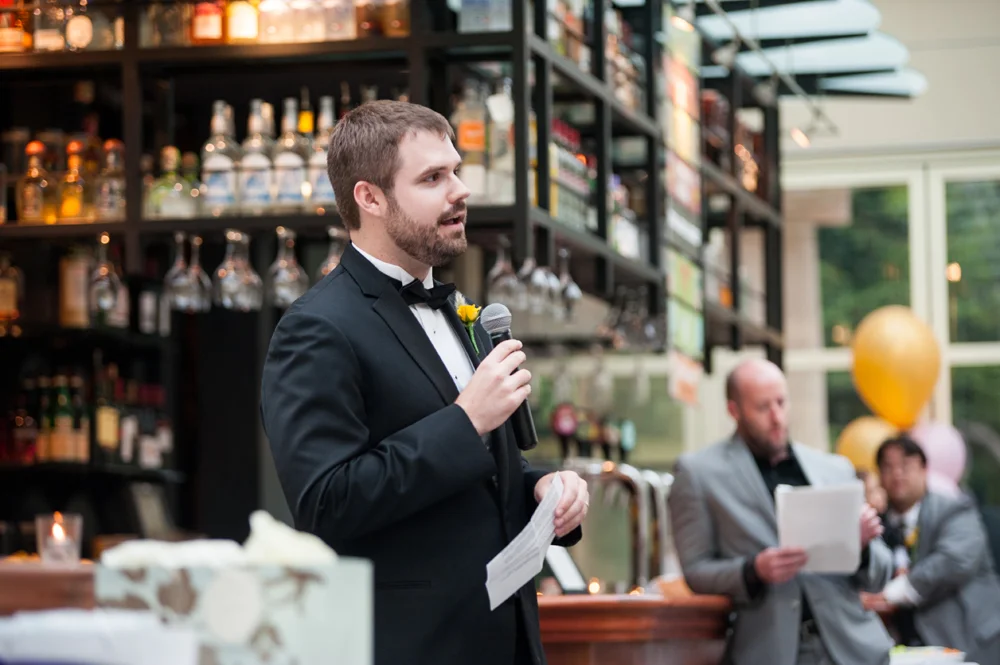 Best man giving a toast at wedding reception at the Beach Chalet Brewery