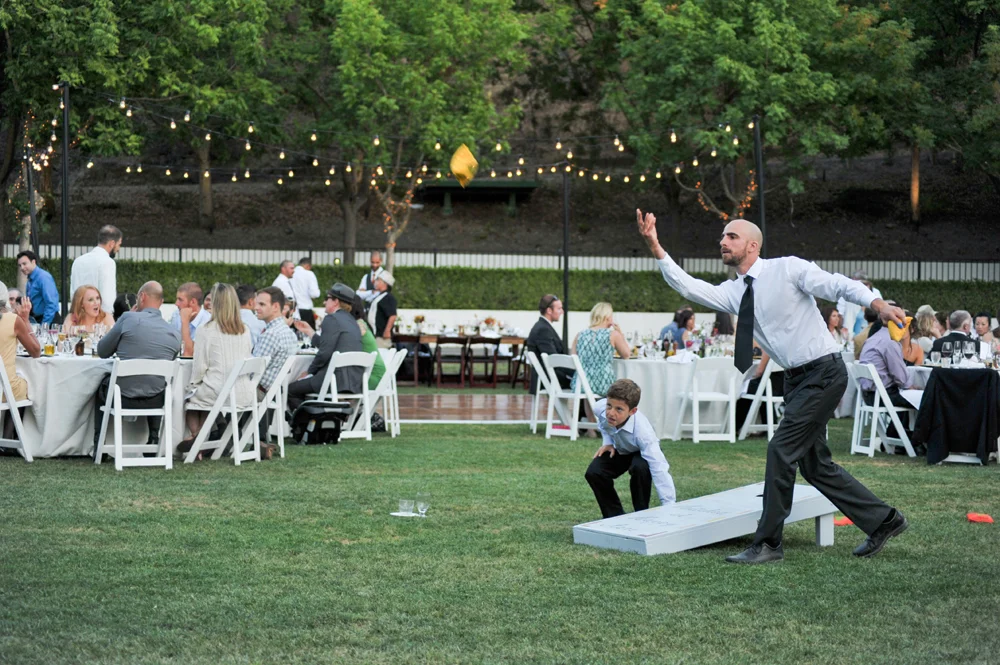 Wedding guest playing cornhole