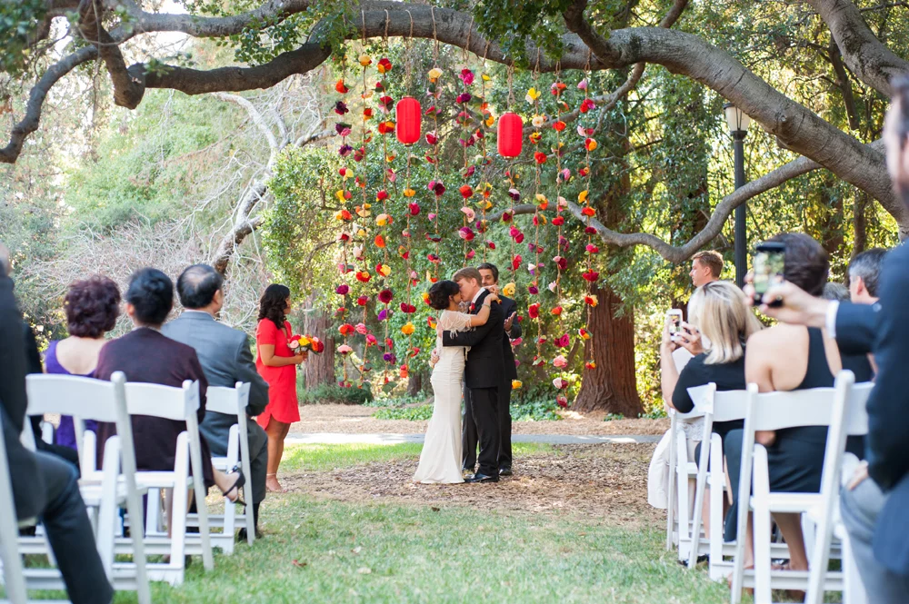 Bride and groom kiss during wedding ceremony at UC Berkeley