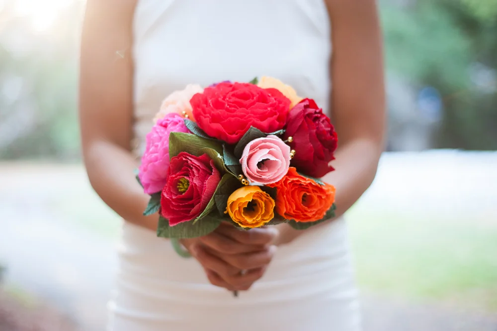 Bride holding bouquet of paper flowers at UC Berkeley