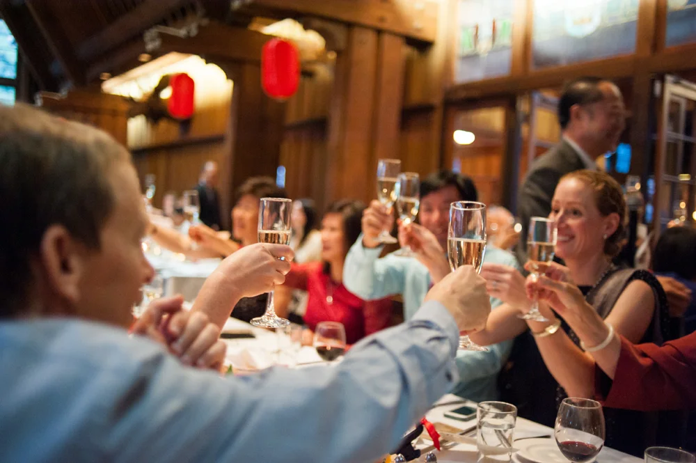 Wedding guests raise their glasses