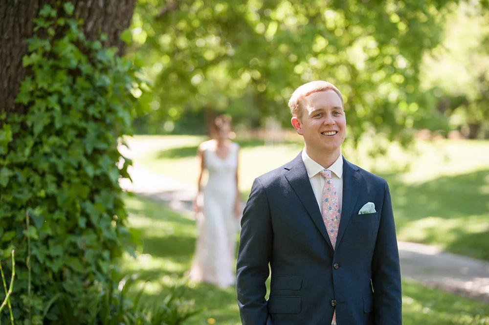 Groom waiting for bride during first look at Dawn Ranch wedding