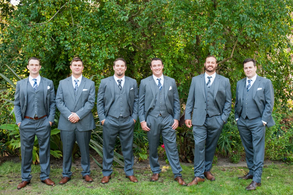 Groomsmen in front of plant wall at Rancho Soquel