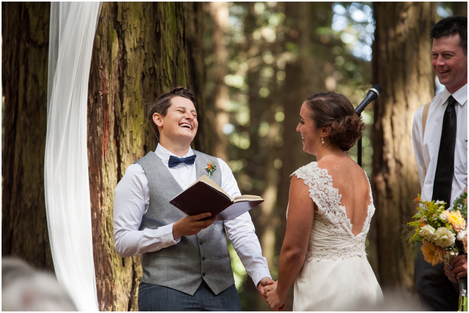 Couple laughing during wedding ceremony in the redwoods