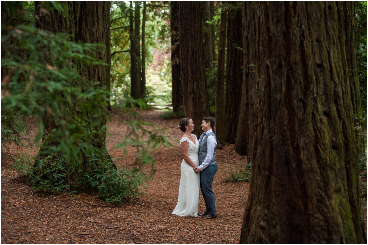 Married couple surrounded by redwoods at Roberts Recreation Area in the Oakland Hills
