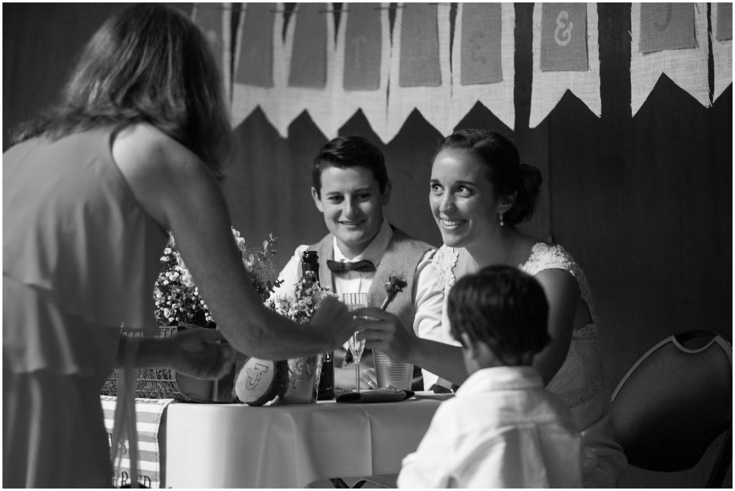 Wedding guest talking to couple during reception at Sequoia Lodge