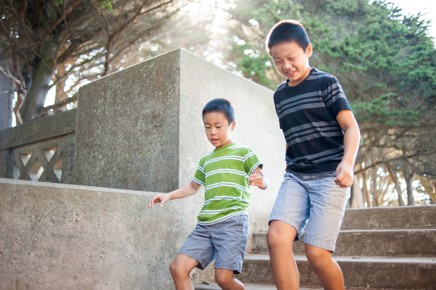 Young brothers racing each other down steps at San Francisco park