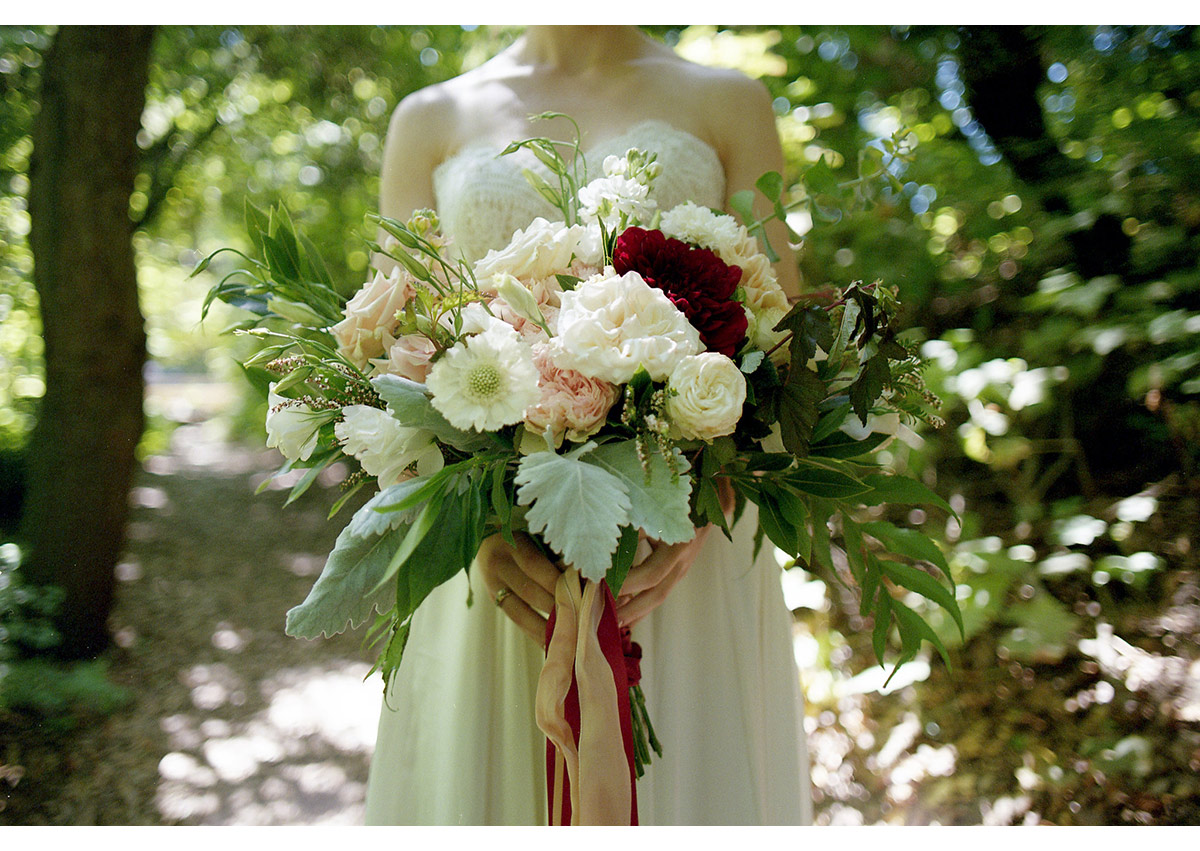 Detail photo of bride holding large flower bouquet