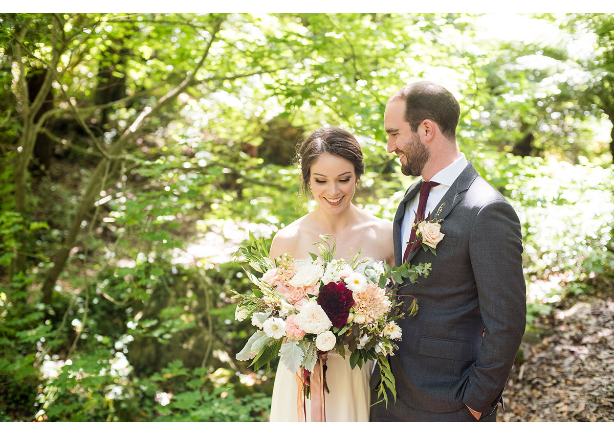 Candid photo of bride and groom in woods