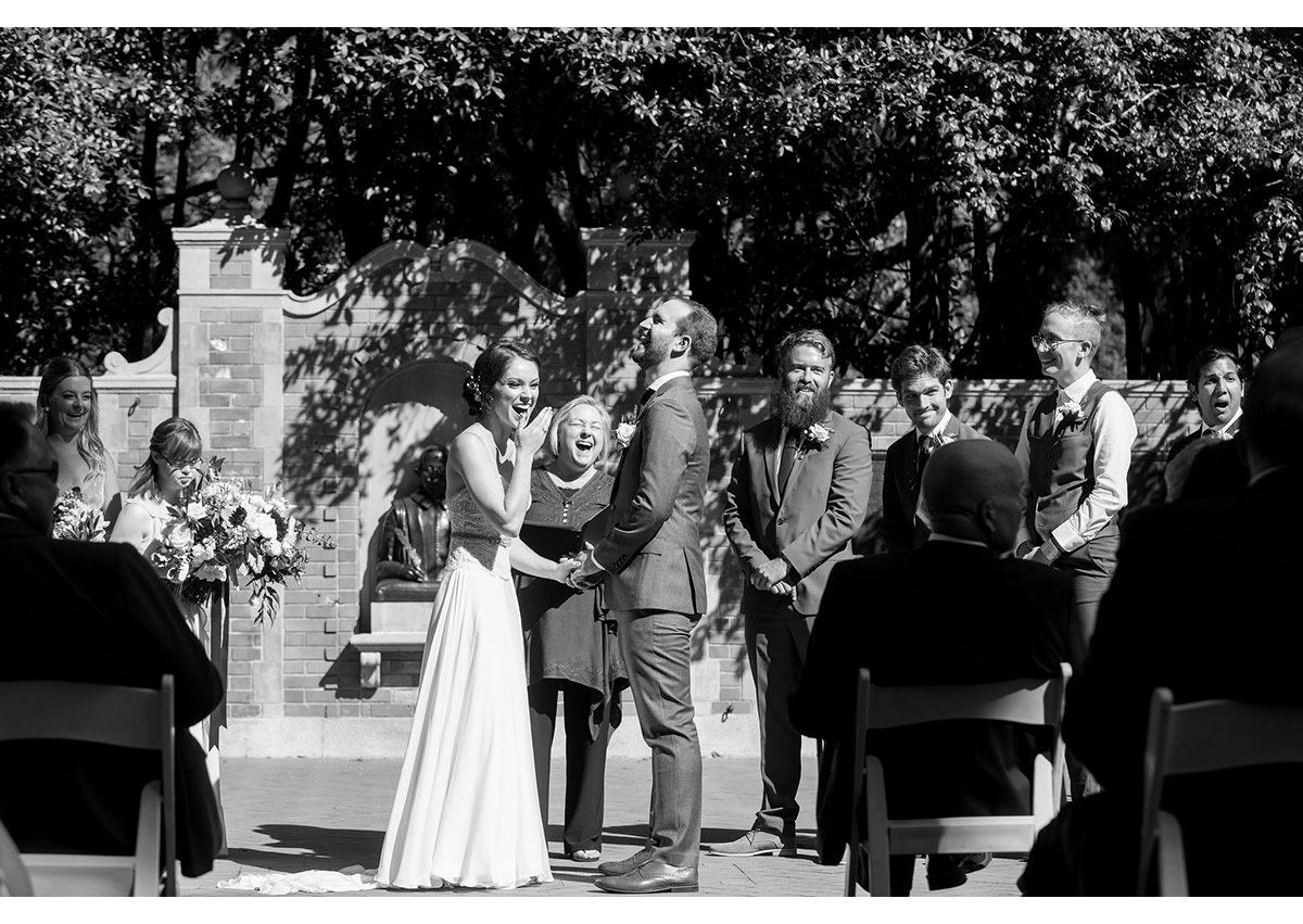 Bride and groom laughing at Shakespeare Garden wedding ceremony