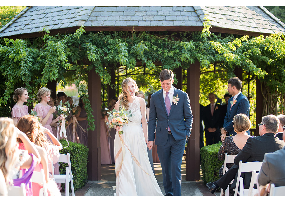 Happy bride and groom walking down aisle after wedding ceremony at Heather Farm gardens