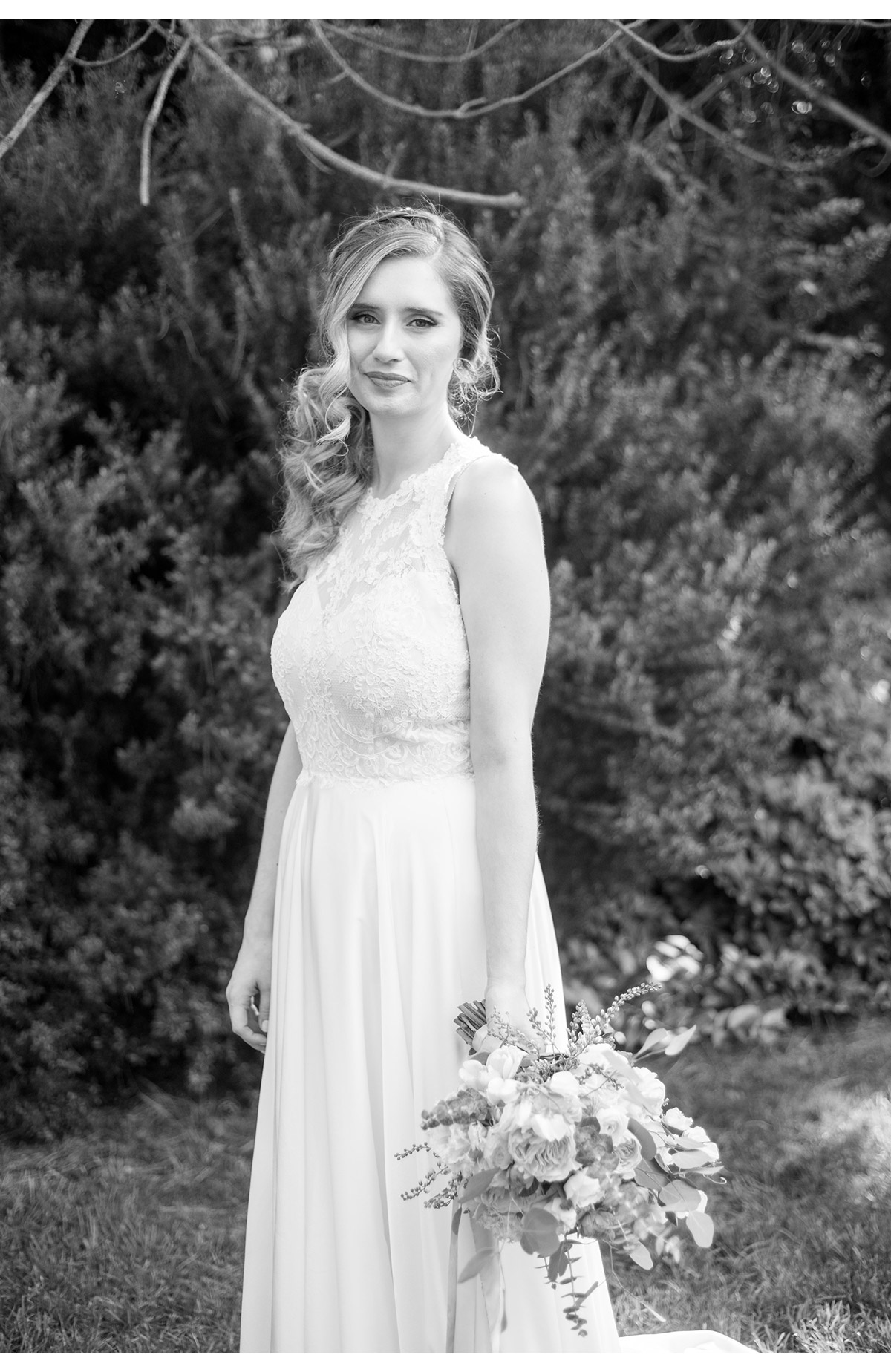 Black and white portrait of bride holding bouquet