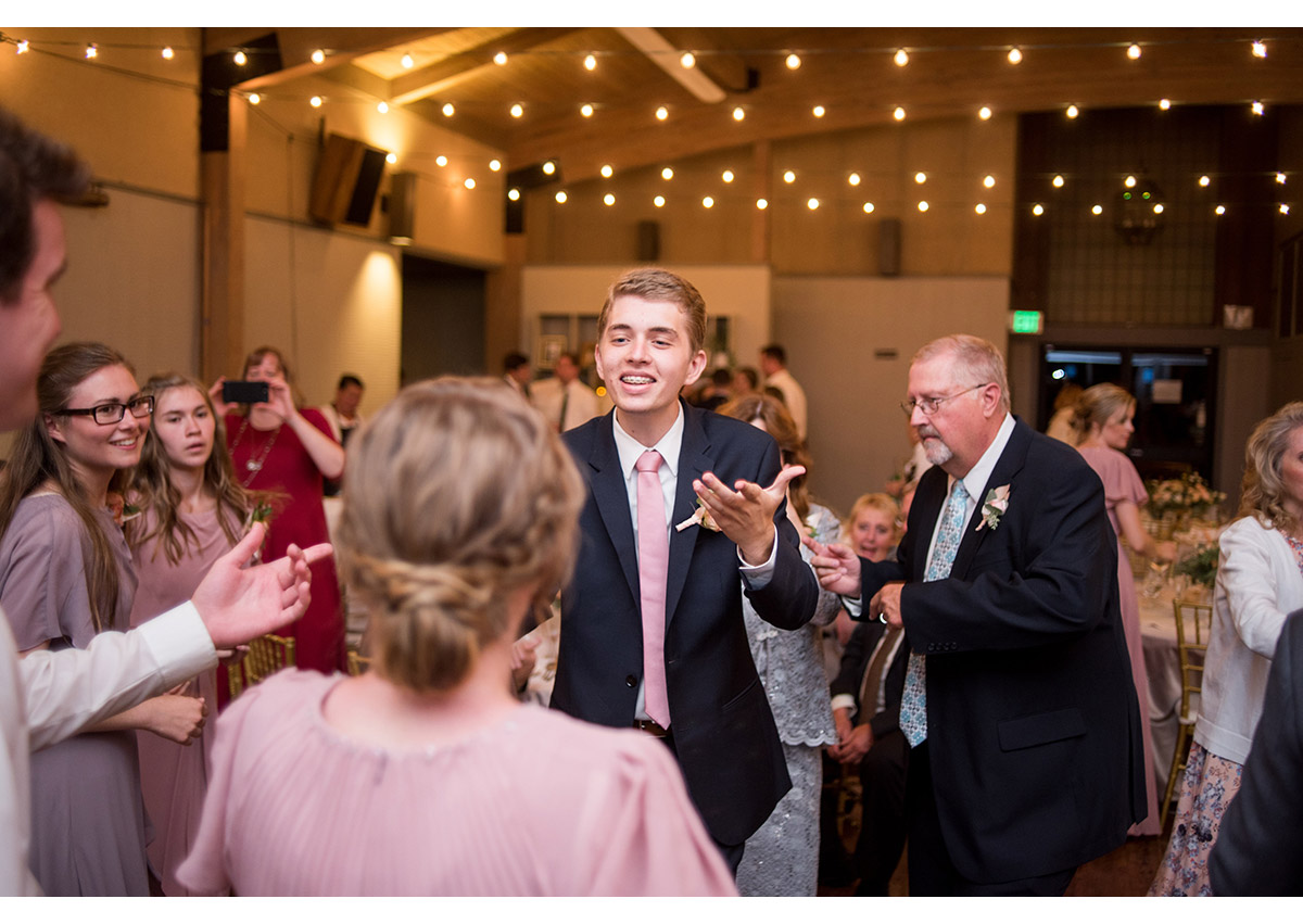 Brother of bride dancing with bridesmaid