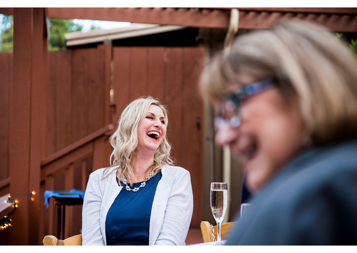 Wedding guest laughing during toast at the Mountain Terrace