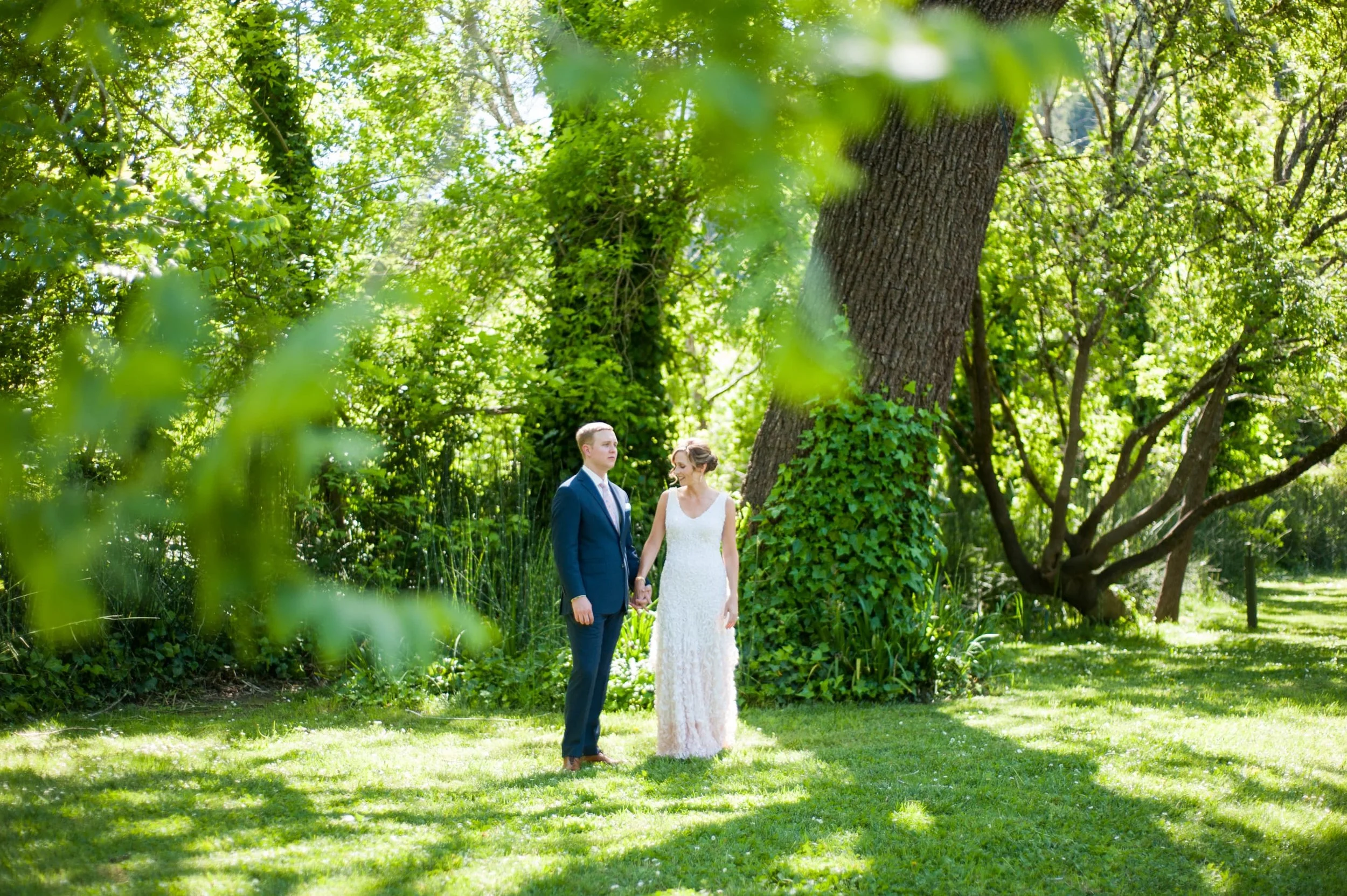 Bride and Groom surrounded by lush greenery in Guerneville