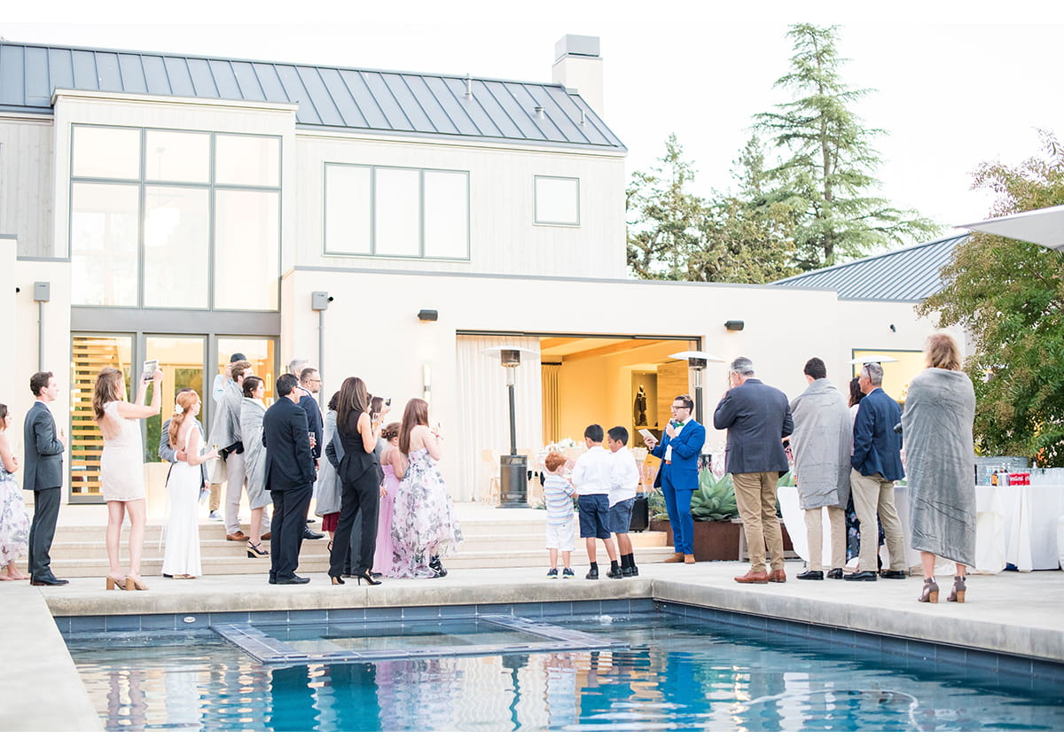 Wedding guests poolside during toast