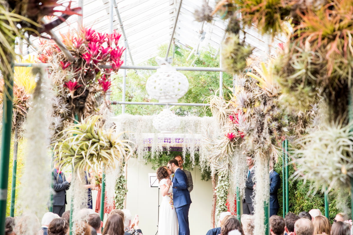 Bride and Groom kiss at Shelldance Orchid Garden wedding