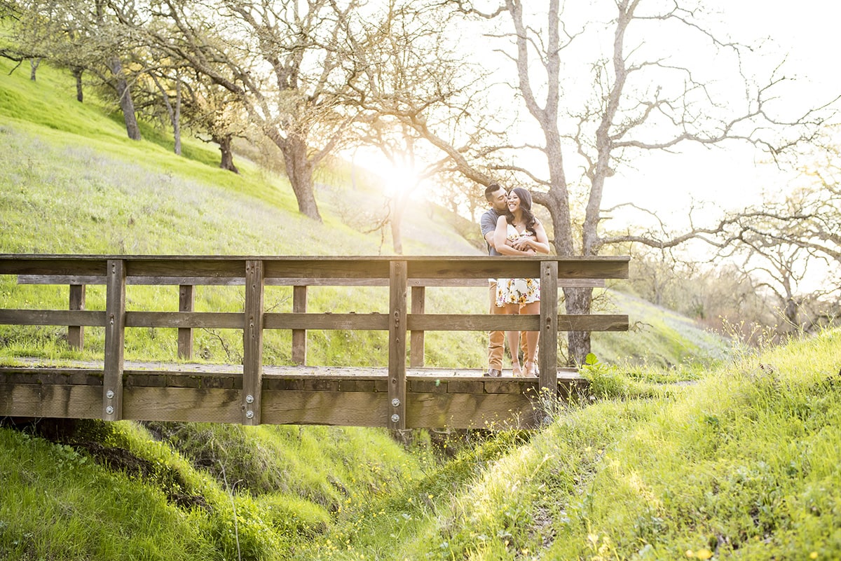 Engaged couple on wooden bridge in East Bay hills