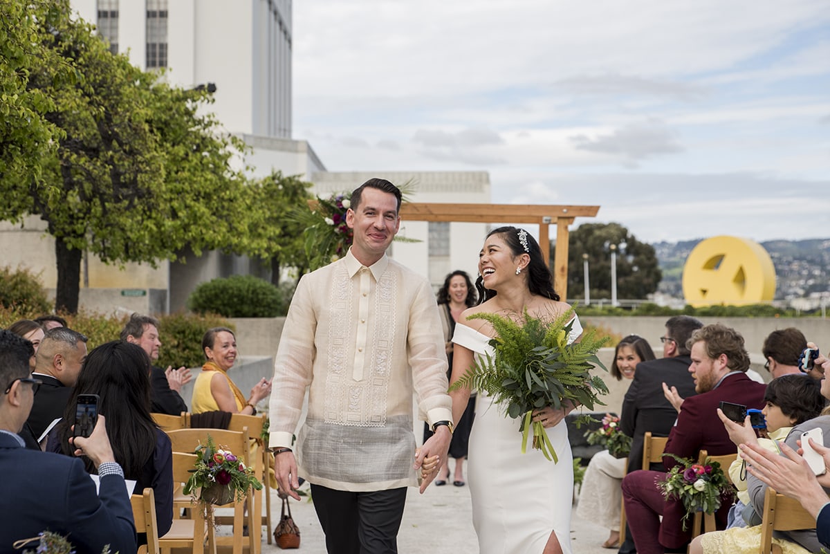 Bride and Groom walking down aisle after wedding ceremony in Oakland
