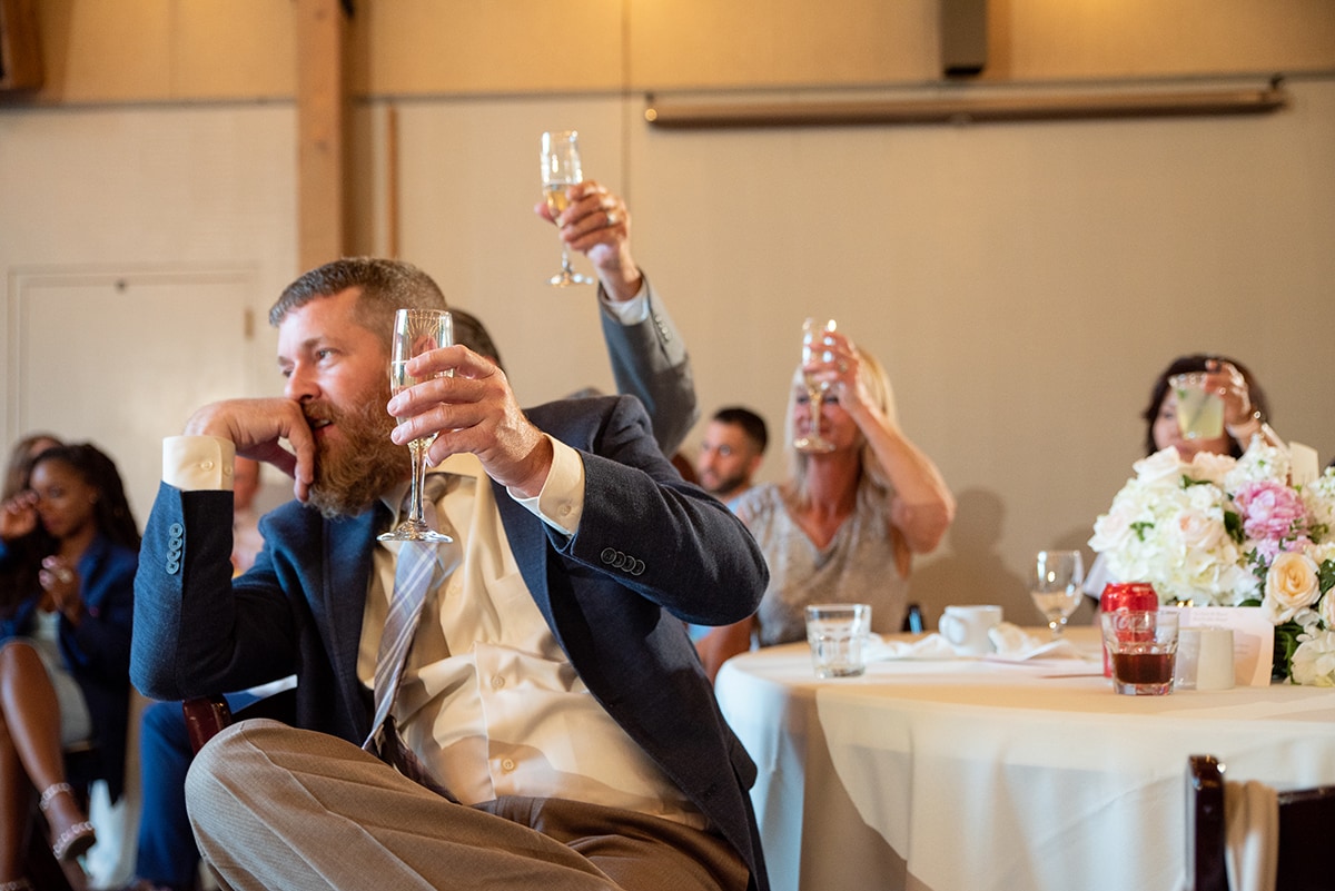 Wedding guest raising his champagne glass