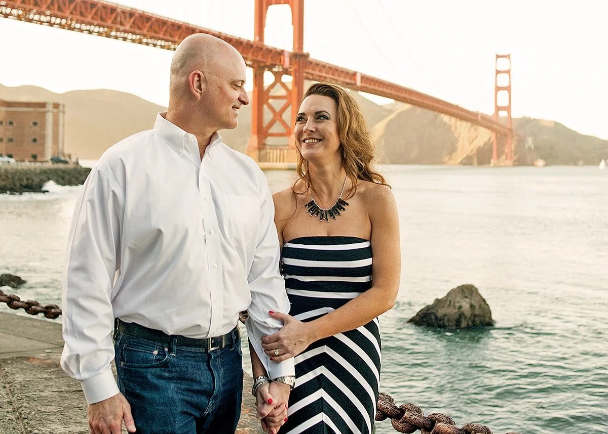 Couple walking at the base of the Golden Gate Bridge in San Francisco