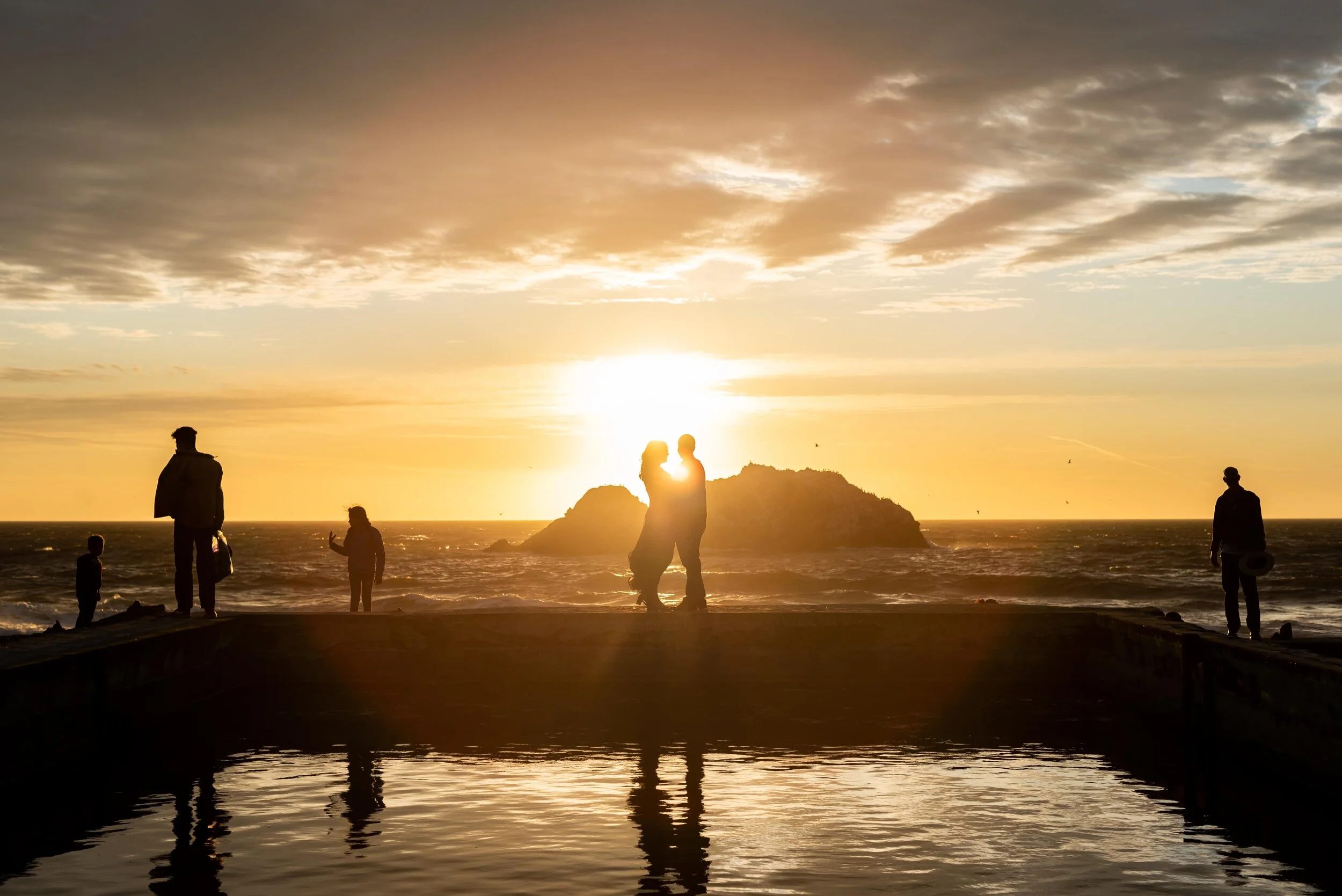 Silhouette of couple and people at sunset at Sutro Baths